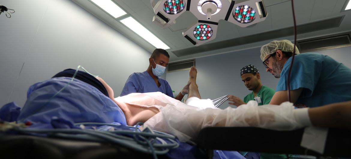 A patient is treated in surgery at Al-Quds hospital in Gaza.