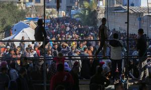 People gather at an UNRWA flour distribution point in central Gaza, where hunger and urgent needs persist amid the ongoing conflict.