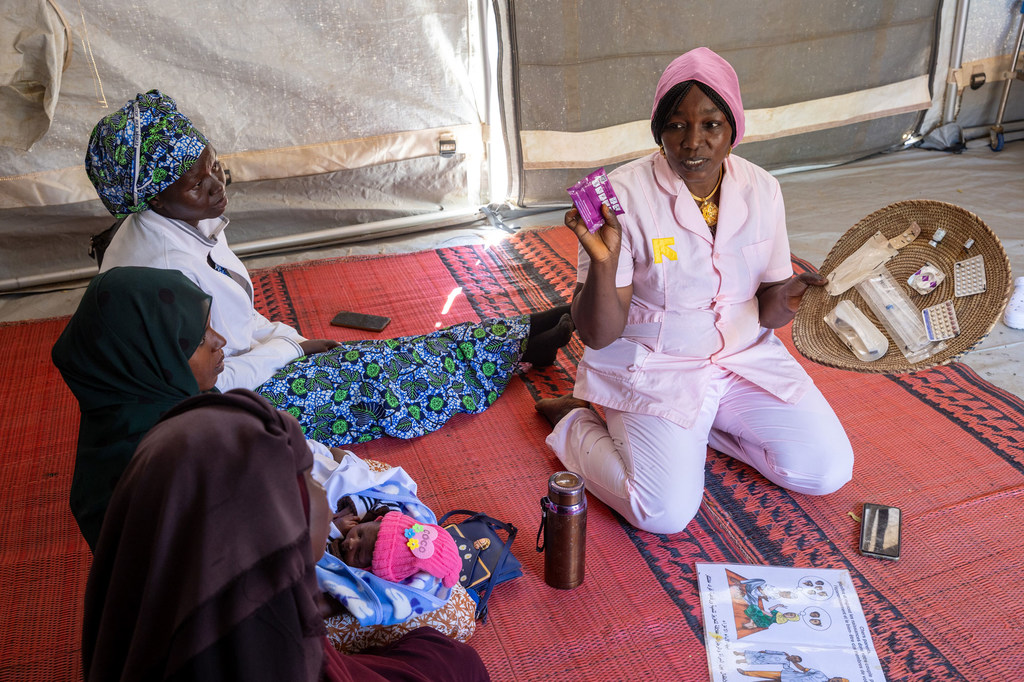 A midwife explains contraceptive options to women at a camp for displaced people in Chad.