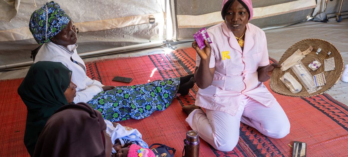 A midwife explains contraceptive options to women at a camp for displaced people in Chad. A midwife explains contraceptive options to women at a camp for displaced people in Chad.