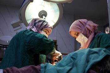 Medical workers perform an emergency operation at the Idlib Maternity Hospital in Syria. 