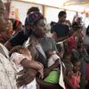 Mothers and children wait in line at Ecole Jean Marie César in Port-au-Prince, Haiti, for a monthly malnutrition screening conducted by a mobile health unit from Medecins du Monde Argentina.