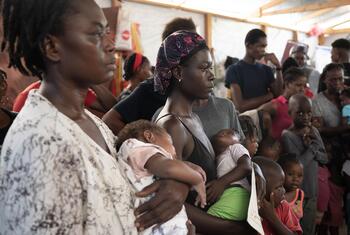 Mothers and children wait in line at Ecole Jean Marie César in Port-au-Prince, Haiti, for a monthly malnutrition screening conducted by a mobile health unit from Medecins du Monde Argentina.