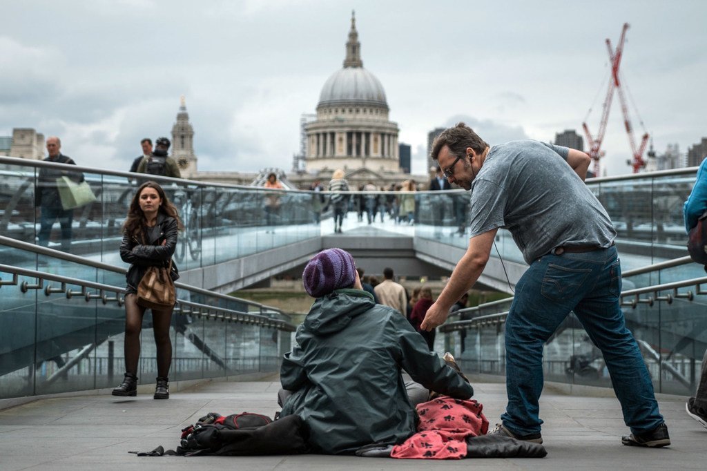 A homeless woman begs for money in the centre of London, United Kingdom
