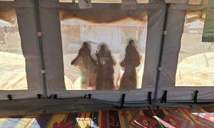 Children peer through a UNICEF tent at a child-friendly space in Kassala state, Sudan.