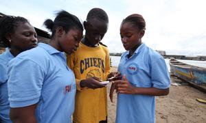 Young people in Monrovia, Liberia, share mobile technology designed to raise awareness about Ebola.