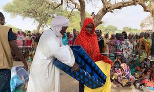 Refugees from Sudan collect relief items  distributed by UNICEF and its partners in Kounfroun, Chad.