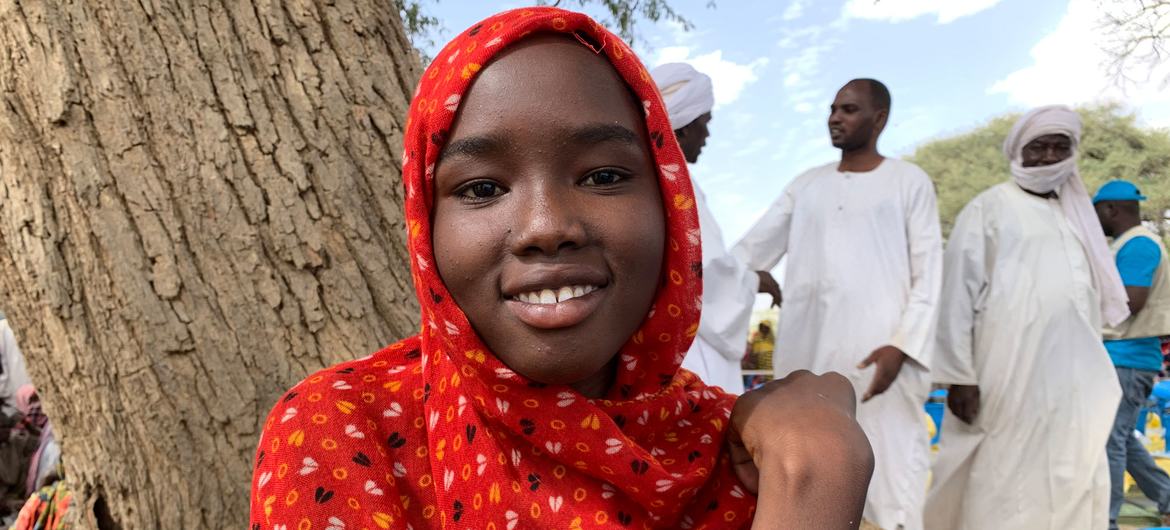 A young girl who fled Sudan with her family waits for a distribution of relief aid in Chad.