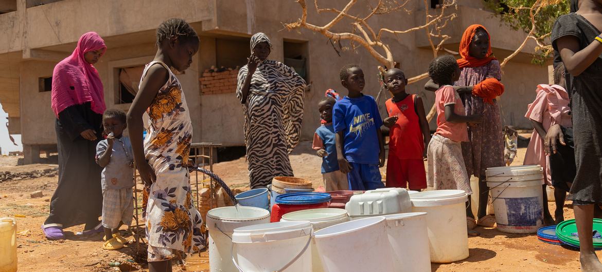 People in Khartoum, Sudan, queue for water.