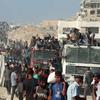 Thousands of people seek aid delivered across the Israeli Zikim border point in northern Gaza.