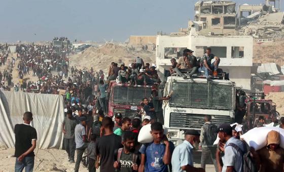 Thousands of people seek aid delivered across the Israeli Zikim border point in northern Gaza.
