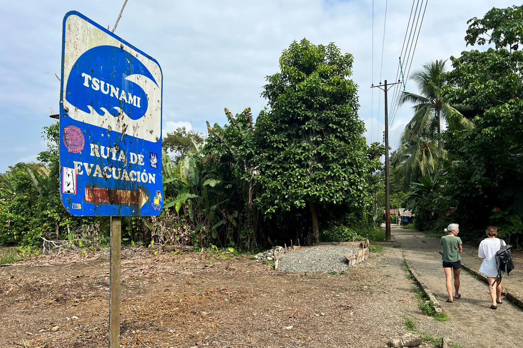 A sign on the Pacific coast of Colombia, shows a tsunami evacuation route.