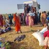 People who have fled El Fasher in Darfur receive aid in Tawila.