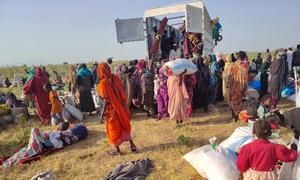 People who have fled El Fasher in Darfur receive aid in Tawila.