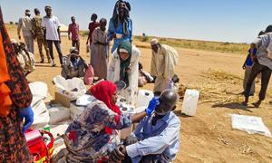 An aid worker provides first aid to an IDP at the Tawila displacement site in North Darfur, Sudan, on October 28, 2025.