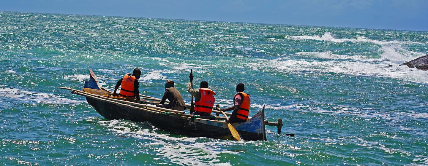 A group of fishers heads out to sea from the village of Mokola.