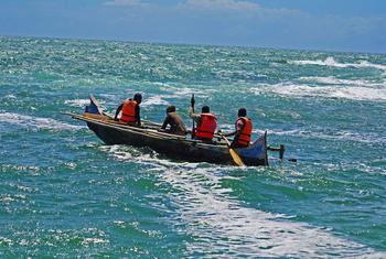 A group of fishers heads out to sea from the village of Mokola.