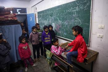 Palestinian children play in a classroom at a displaced shelter in Rafah city, Gaza.
