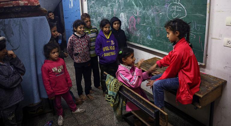 Children play in a classroom at a shelter located in Rafah city.