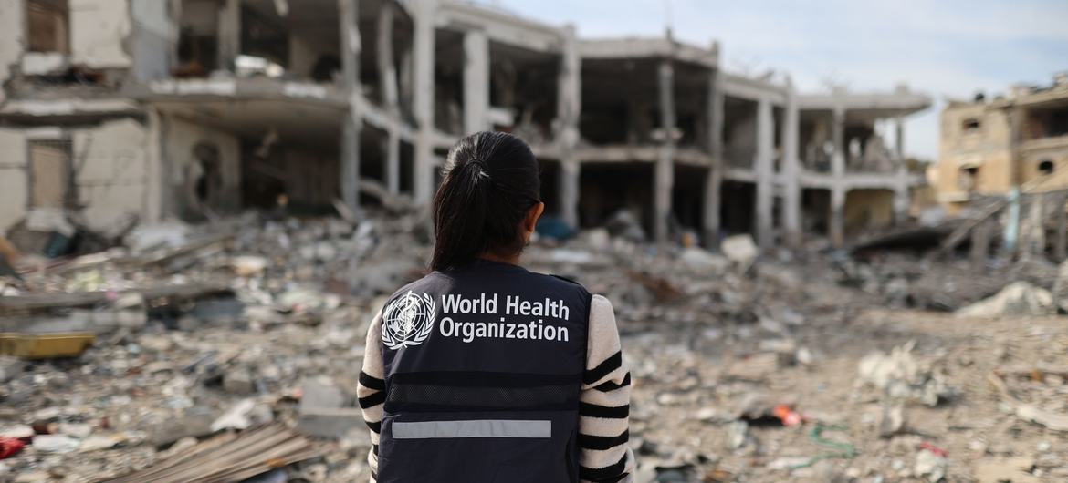 A WHO worker assesses a destroyed hospital in northern Gaza.