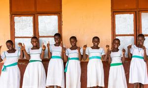 Girls give the thumbs-up at a school in Ghana.