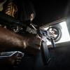 A Haitian police officer keeps watch while patrolling the streets of Port-au-Prince in an armoured vehcile.