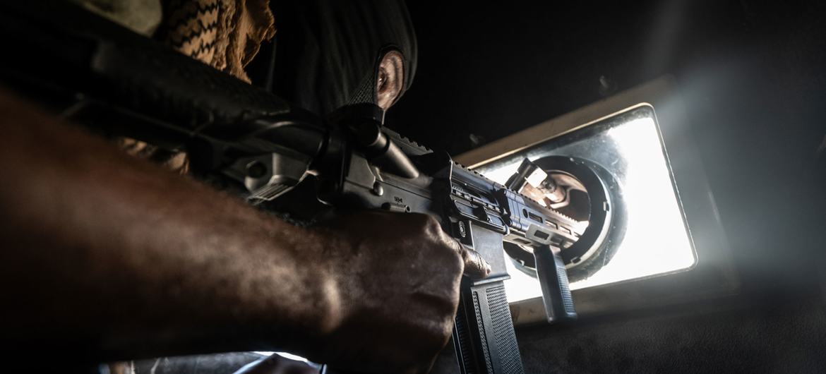 A Haitian police officer keeps watch while patrolling the streets of Port-au-Prince in an armoured vehcile.