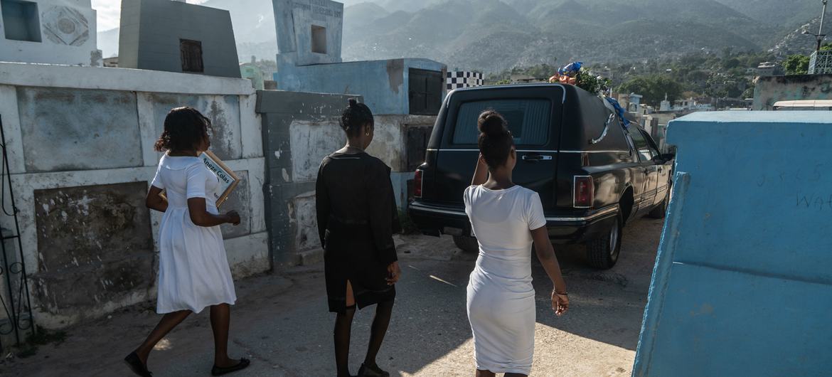 A funeral procession passes by the Grand Cemetery in downtown Port-au-Prince.