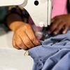 A cooperative member sews a garment at Olango Sindaw Ko Kauyagan Producer cooperative in Piagapo, village.