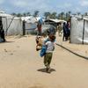 Un niño lleva sus pertenencias en el campo de desplazados de Al Mawasi, en Gaza.