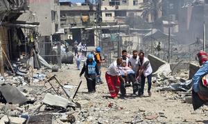 UN staff and medical workers evacuating patients from a hospital in northern Gaza in late May 2025.