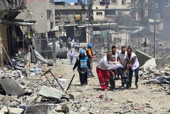 UN staff and medical workers evacuating patients from a hospital in northern Gaza in late May 2025.