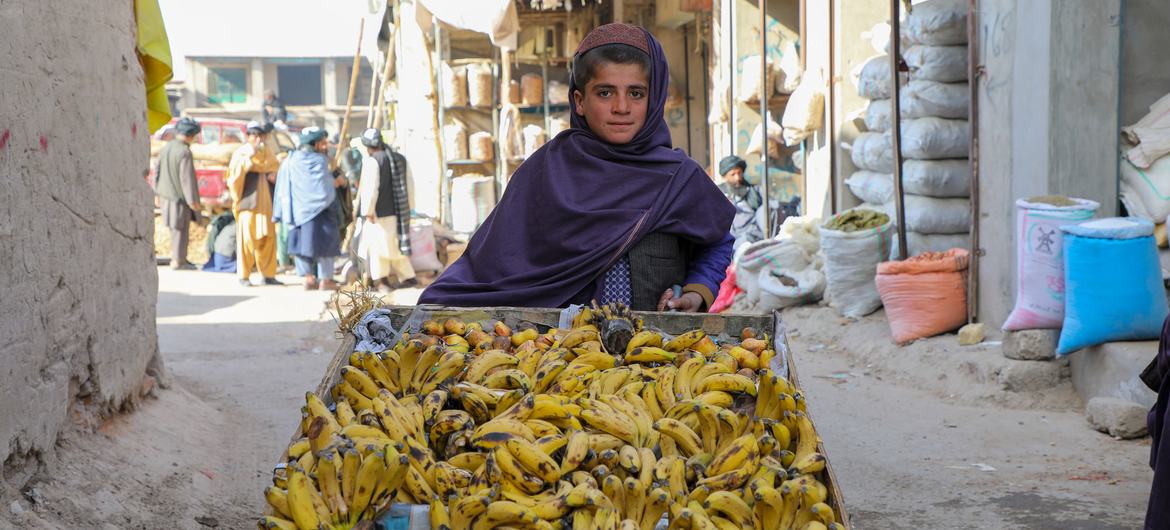 A 12-year-old boy, who does not go to school, sells bananas in Uruzgan Province in western Afghanistan. 