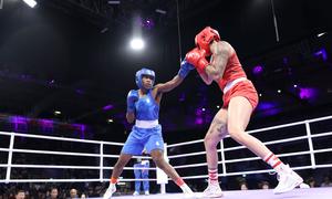 Refugee athlete Cindy Ngamba (left) is set to become the first ever medalist for the Refugee Olympic Team.