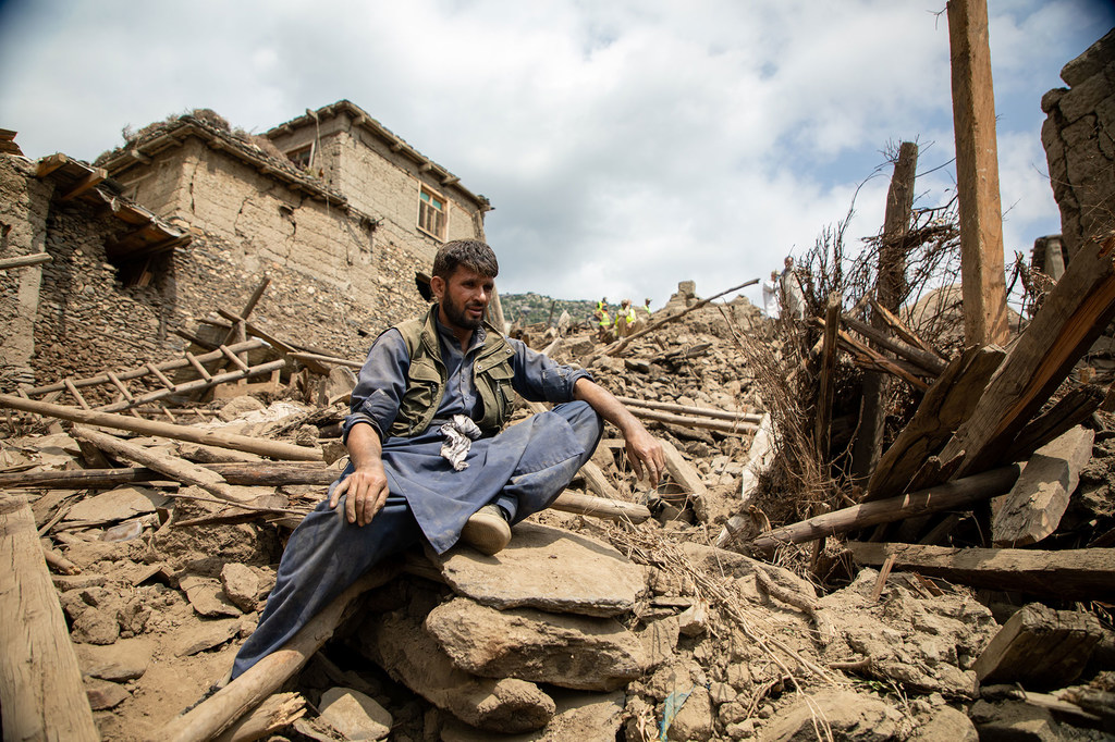 A villager in Kunar province, Afghanistan, clears rubble following the earthquake which struck the country at the end of August.