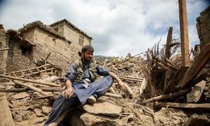 A villager in Kunar province, Afghanistan, clears rubble following the earthquake which struck the country at the end of August.