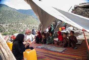 A family, including children, sits inside a tent in Ghazi Abad village, Kunar province, Afghanistan, after an earthquake destroyed their home.