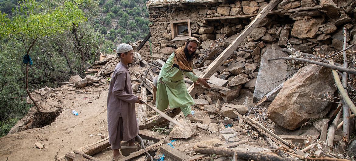 A father and son clear rubble following an earthquake in early September in Kunar province, Afghanistan.