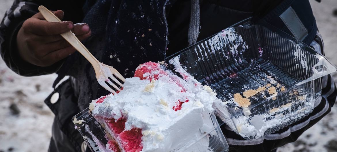 A consumer in Mongolia eats a sugary desert. A consumer in Mongolia eats a sugary desert.