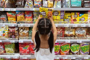 A young girl chooses sweets at a supermarket in Lima, Peru.
