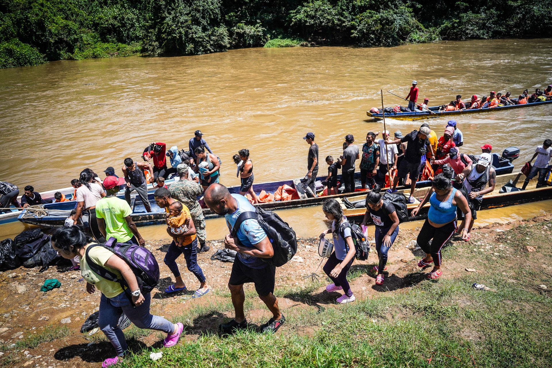 Migrants come ashore from the Chucunaque River after crossing the Darién jungle.