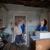 Human rights officers examine a kitchen where a rocket landed in Posad-Pokrovske in the Kherson region of Ukraine.