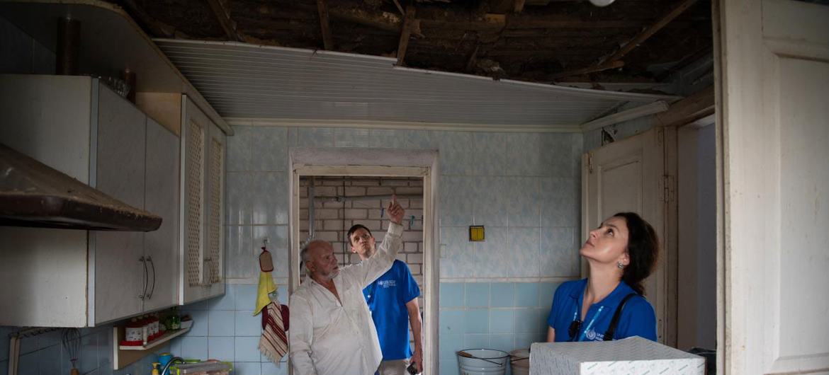 Human rights officers examine a kitchen where a rocket landed in Posad-Pokrovske in the Kherson region of Ukraine (file).