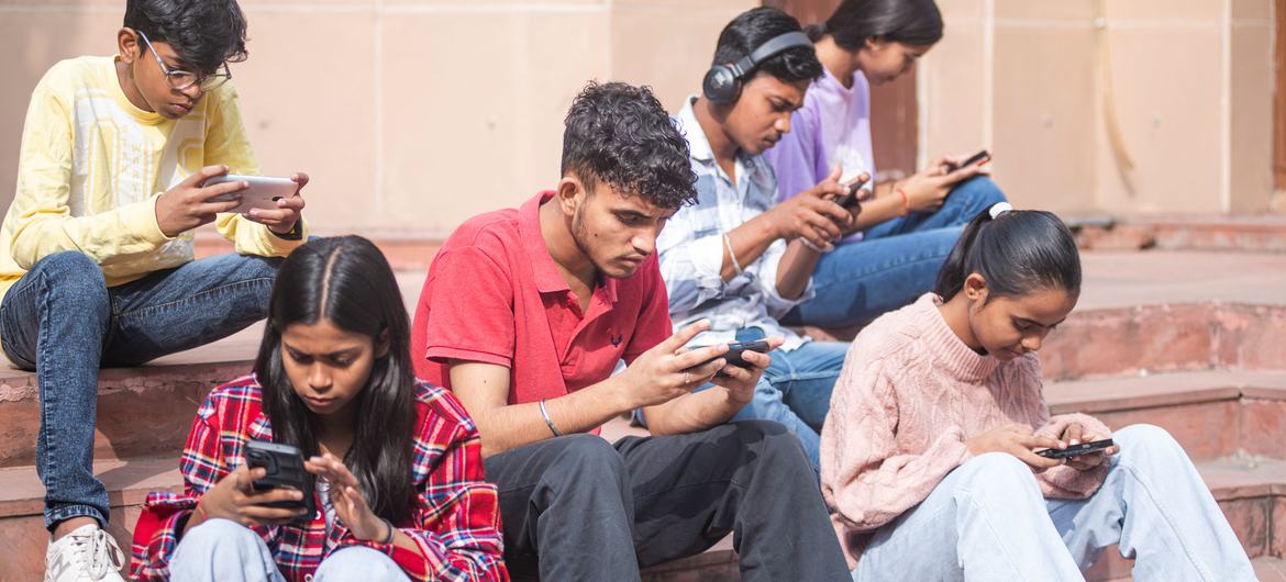 Young people in Delhi, India use their smartphones.