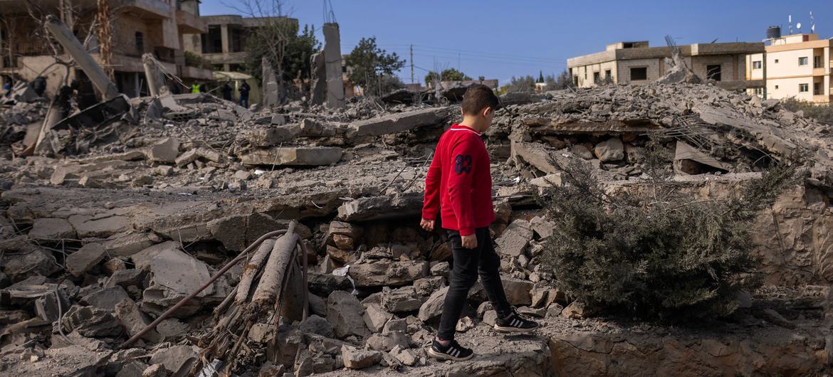 A a 5-year-old walks amongst the ruins of houses in southern Lebanon.