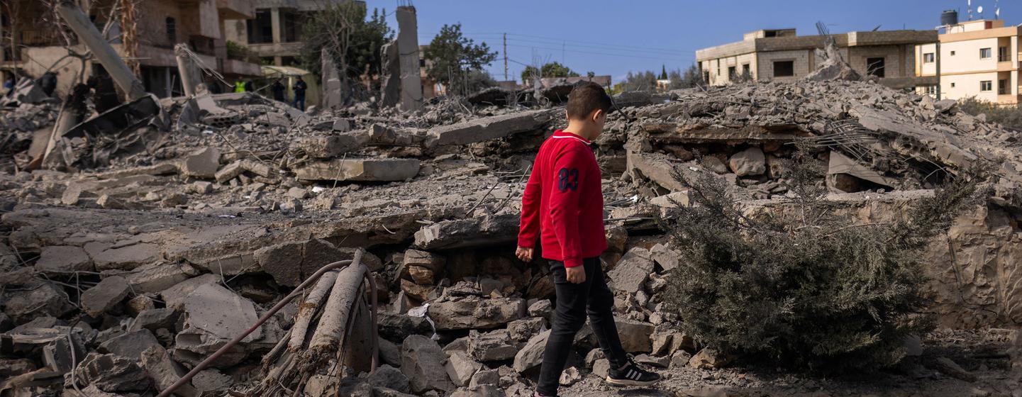 A a 5-year-old walks amongst the ruins of houses in southern Lebanon.