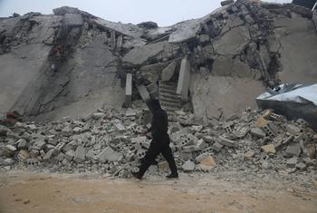 Un homme marche devant un bâtiment endommagé par le séisme à Idlib, en Syrie.