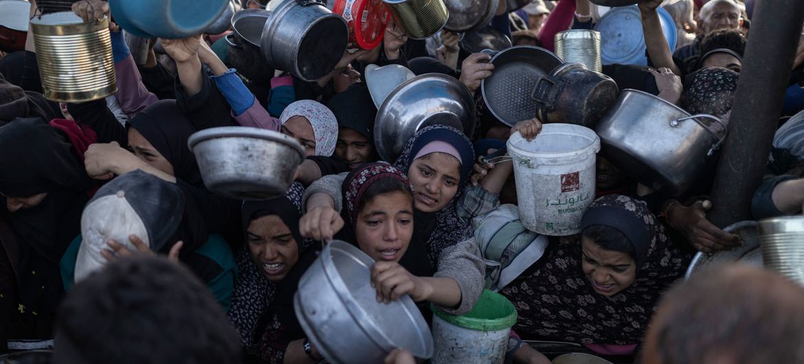 People gather at a food distribution point in Gaza City in February 2025.