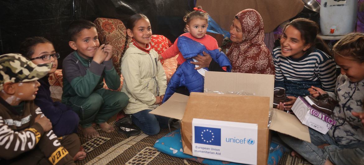 Children and their families in central Gaza receive winter clothes.