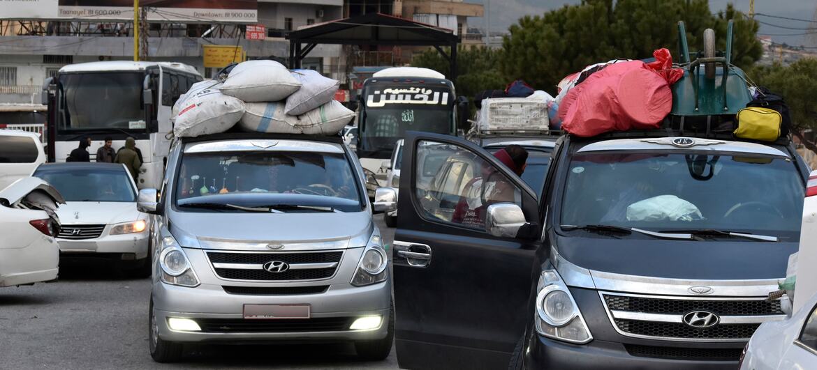 Cars loaded with luggage and belongings wait in a queue at the Masnaa border point in Lebanon, as people flee conflict and Israeli bombing to cross into Syria.